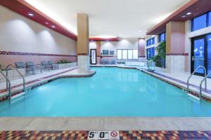 a large swimming pool in a hotel room at Embassy Suites by Hilton Saint Louis Saint Charles in St. Charles