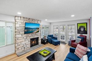 a living room with a fireplace and a tv at 256 Americana in Huntington Beach