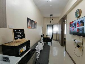 a living room with a stove and a dining room at Pasay Coast Residences JCMJ in Manila
