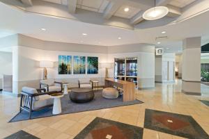 a lobby of a hotel with a waiting room at Embassy Suites by Hilton Tampa USF Near Busch Gardens in Tampa