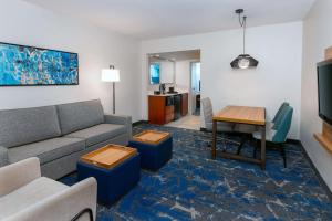 a living room with a couch and a table at Embassy Suites by Hilton Tampa USF Near Busch Gardens in Tampa
