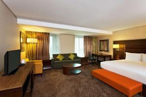 a large hotel room with a bed and a couch at Hilton Garden Inn, Trivandrum in Trivandrum