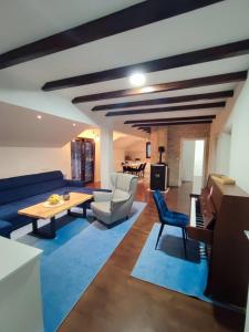 a living room with a couch and a table at Apartman Zdenka 2 in Livno +14 photos