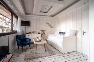 a bedroom with a bed and a table and a chair at Deauville : magnifique studio en face du Casino ! in Deauville