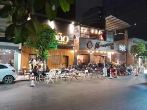 un grupo de personas sentadas en mesas fuera de un restaurante en Hermoso Apart Barrio Sur en San Miguel de Tucumán