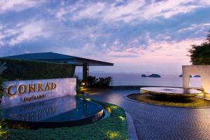 a resort with a pool and a sign that reads condominium at Conrad Koh Samui in Taling Ngam Beach