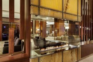 a lobby with couches and chairs in a building at DoubleTree by Hilton Hotel & Conference Centre Warsaw in Warsaw