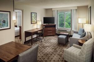 a hotel room with a desk and a living room at Homewood Suites by Hilton Wallingford-Meriden in Wallingford