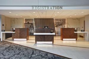 a lobby with a reception desk in a building at Embassy Suites by Hilton Omaha Downtown Old Market in Omaha