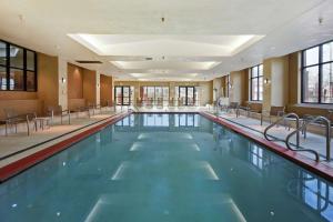 a large swimming pool with chairs in a building at Embassy Suites by Hilton Omaha Downtown Old Market in Omaha