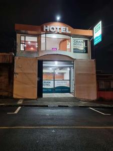 a hotel with its door open on a street at night at Gran Hotel Desamparados in Desamparados