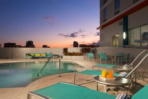 a swimming pool with chairs and tables on a building at Hampton Inn & Suites by Hilton Miami Downtown/Brickell in Miami