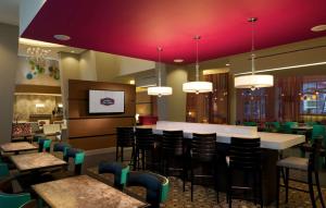 a restaurant with a bar with chairs and tables at Hampton Inn & Suites by Hilton Miami Downtown/Brickell in Miami