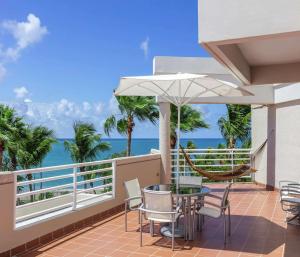 a balcony with a table and chairs and the ocean at Hilton Ponce Golf & Casino Resort in Ponce