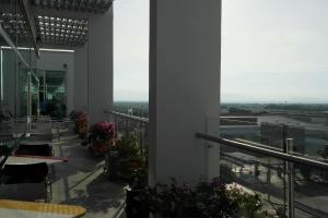 a balcony of a building with tables and flowers at Hampton By Hilton Valledupar in Valledupar