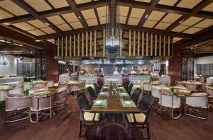 a dining room with tables and chairs in a restaurant at Hilton Dali Resort & Spa in Dali