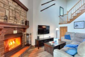 a living room with a couch and a fireplace at Sweet Getaway in Mont-Tremblant