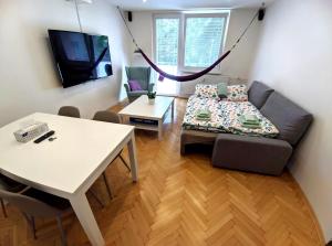 een woonkamer met een bank en een tafel bij Friends & Family Apartment in Trenčín
