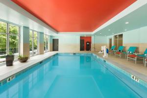 a large swimming pool with blue water in a building at Homewood Suites by Hilton Atlanta Perimeter Center in Atlanta