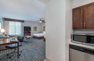 a hotel room with a kitchen and a living room at Homewood Suites by Hilton Atlanta Perimeter Center in Atlanta