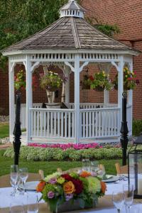 a white gazebo with flowers on a table at Hilton Mississauga/Meadowvale in Mississauga