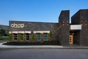 a brick building with a chop sign on it at Hilton Mississauga/Meadowvale in Mississauga