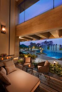 a living room with a view of a pool at Conrad Pune in Pune
