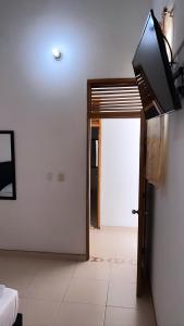 Zimmer mit einer Tür und einem TV an der Wand in der Unterkunft HOTEL BOUTIQUE CRISTOFF in Apartadó