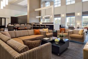 a lobby with couches and tables in a building at Hampton Inn & Suites Rosemont Chicago O'Hare in Rosemont