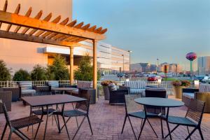 a patio with tables and chairs and a pergola at Hampton Inn & Suites Rosemont Chicago O'Hare in Rosemont