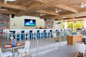 a restaurant with a bar with blue stools at Hilton Orlando Buena Vista Palace - Disney Springs Area in Orlando