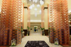 a hallway with orange columns in a hotel lobby at Hilton Garden Inn Greensboro Airport in Greensboro