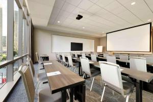 a conference room with tables and chairs and a whiteboard at Homewood Suites by Hilton Chicago Downtown West Loop in Chicago