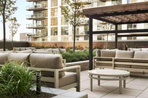 芝加哥Hampton Inn Chicago West Loop Fulton Market Area的带沙发和桌子的庭院和大楼