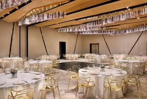 einen Bankettsaal mit weißen Tischen, Stühlen und Kronleuchtern in der Unterkunft AlRayyan Hotel Doha, Curio Collection by Hilton in Doha + 37 Fotos