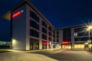 a building with a sign on the side of it at Hampton By Hilton Aberdeen Airport in Dyce