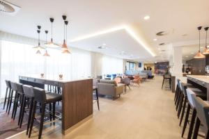 a bar in a restaurant with chairs and tables at Hampton By Hilton Aberdeen Airport in Dyce