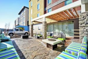 a patio with chairs and a table in front of a building at Home2 Suites By Hilton Smyrna Nashville in Smyrna