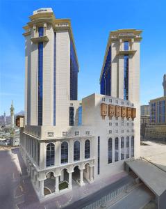 un rendimiento de un edificio con dos edificios altos en Hilton Makkah Convention Hotel en Makkah