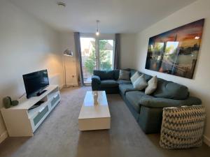 a living room with a couch and a tv at Spacious Flat in Central Street in Street