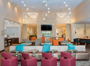 a lobby with a waiting area with pink and blue chairs at Homewood Suites By Hilton Allentown Bethlehem Center Valley in Center Valley