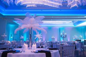 a banquet room with white tables and a palm tree at Homewood Suites By Hilton Allentown Bethlehem Center Valley in Center Valley