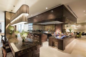 a large kitchen with a large island in a house at Conrad Bengaluru in Bangalore