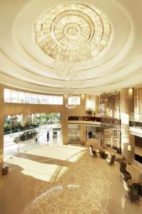 a large lobby with a ceiling with a chandelier at Conrad Bengaluru in Bangalore