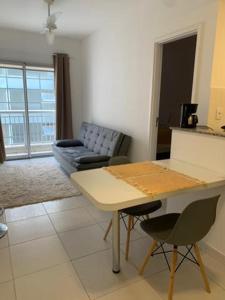 a living room with a table and a couch at Flat Itaguai in Itaguaí +27 photos