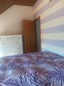 a bedroom with a bed and a dresser at Beiral da Marfida in Amarante