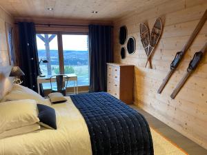 a bedroom with a large bed with a wall of wood at Chalet Standing Exceptionnel in Bolquere Pyrenees 2000