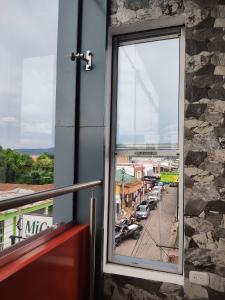 a window of a building with a view of a street at Este Hotel in Estelí