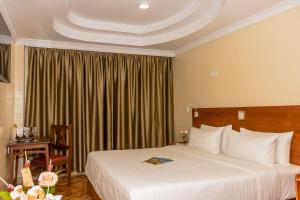 Voodi või voodid majutusasutuse The Glacier Hotel Nanyuki toas