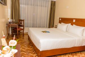 Voodi või voodid majutusasutuse The Glacier Hotel Nanyuki toas